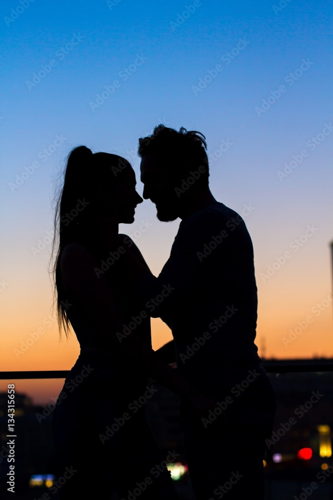 Couple and evening sky background. Silhouettes of lady and man. Would you be mine forever.