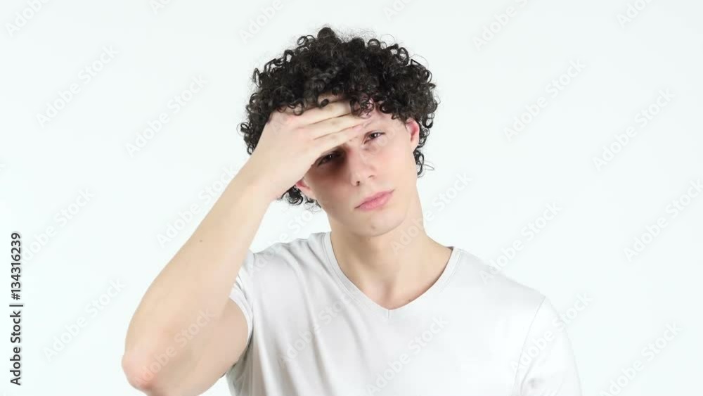 Headache, Frustrated Man with Curly Hairs, white Background Headache, Frustrated Man with Curly Hairs, white Background
