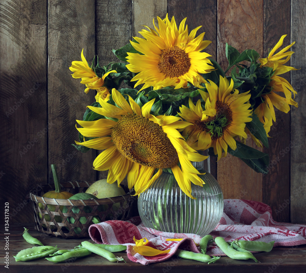 Fototapeta premium sunflowers, pumpkins and peas on the table