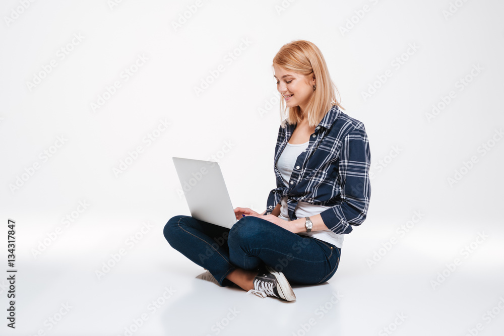 Pretty young woman using laptop computer Pretty young woman using laptop computer