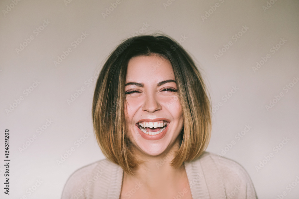 Fototapeta premium Frontal portrait of a beautiful joyful woman,laughing pretty women,head and shoulders portrait 