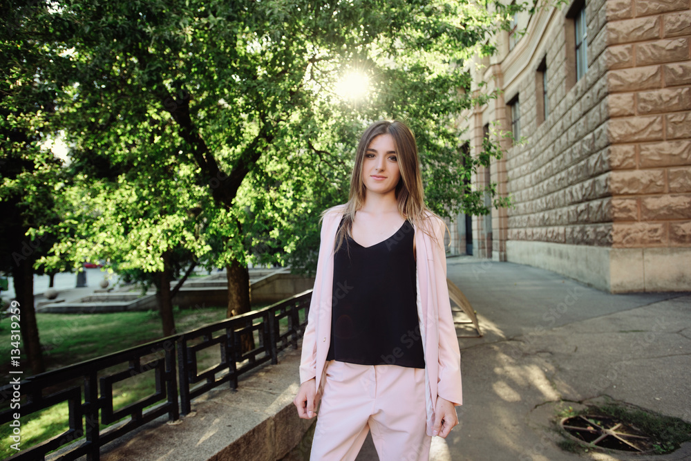 Beautiful white woman in urban background. Businesswoman wearing trousers and tie Beautiful white woman in urban background. Businesswoman wearing trousers and tie