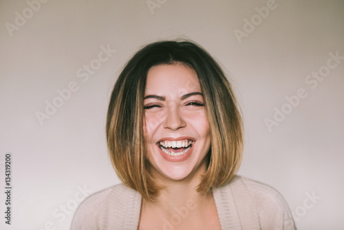 Frontal portrait of a beautiful joyful woman,laughing pretty women,head and shoulders portrait 