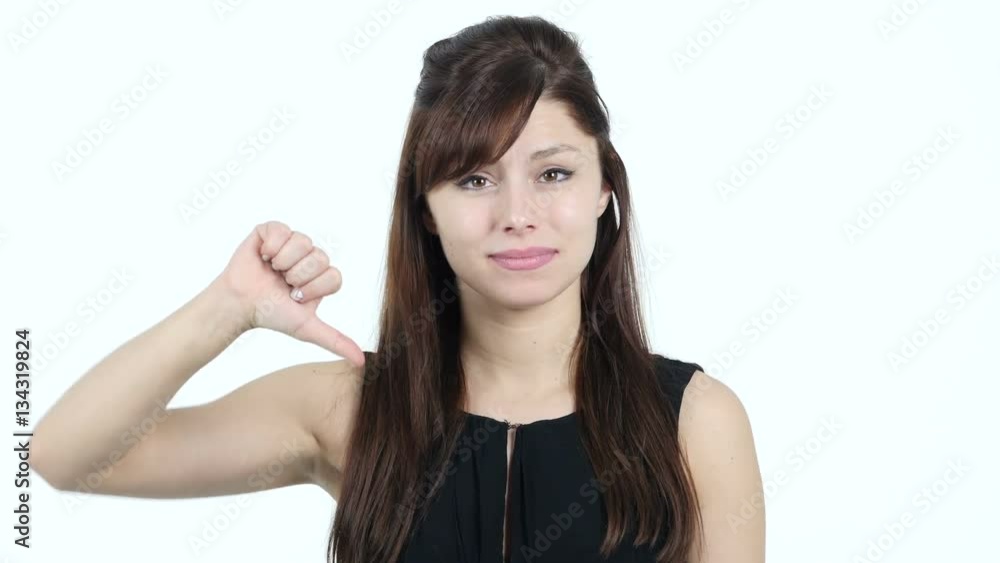 Thumbs Down by Young Girl, White Background Thumbs Down by Young Girl, White Background