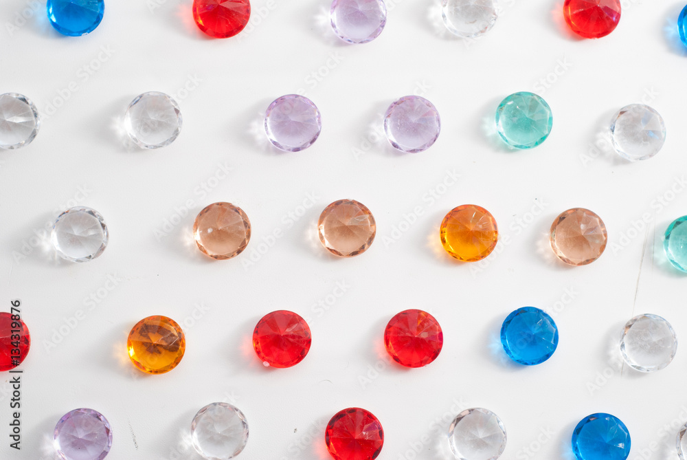 A collection of different faceted stones on a white background