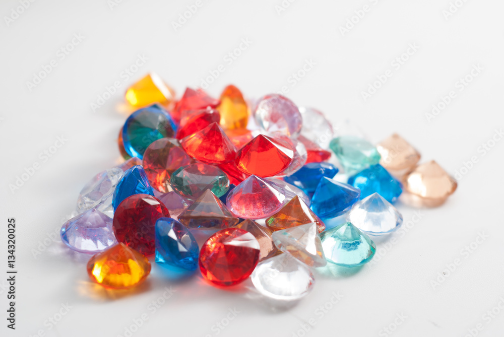 A collection of different faceted stones on a white background