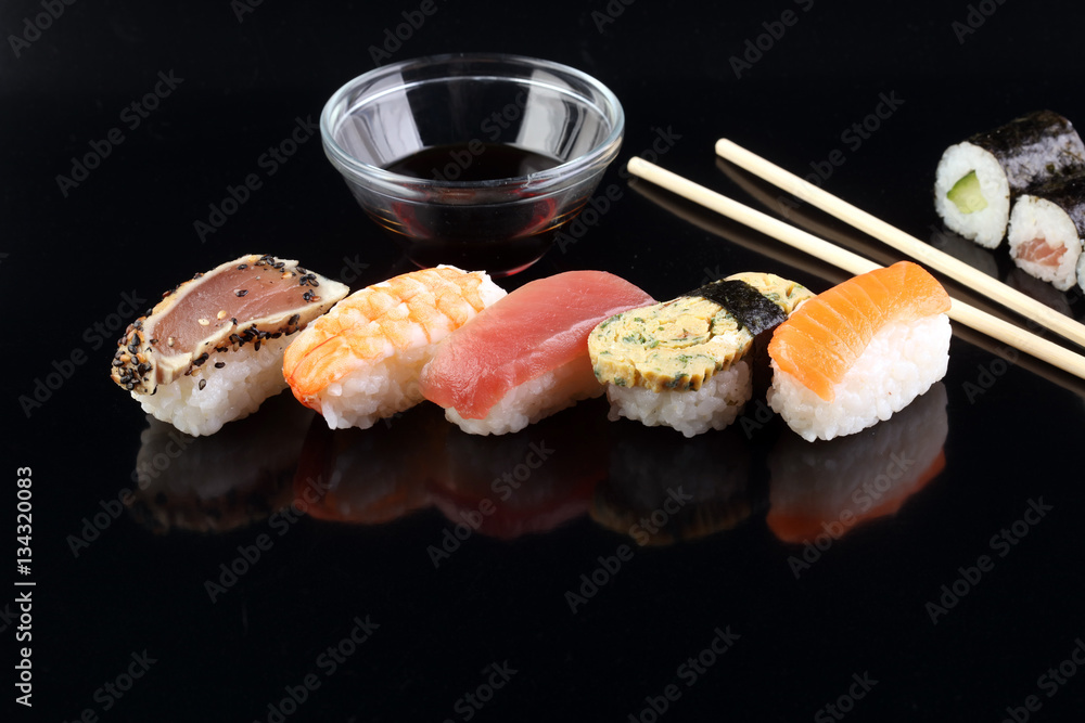 close up of sashimi sushi set with chopsticks and soy - sushi roll with salmon and sushi roll with smoked eel, selective focus. close up of sashimi sushi set with chopsticks and soy - sushi roll with salmon and sushi roll with smoked eel, selective focus.
