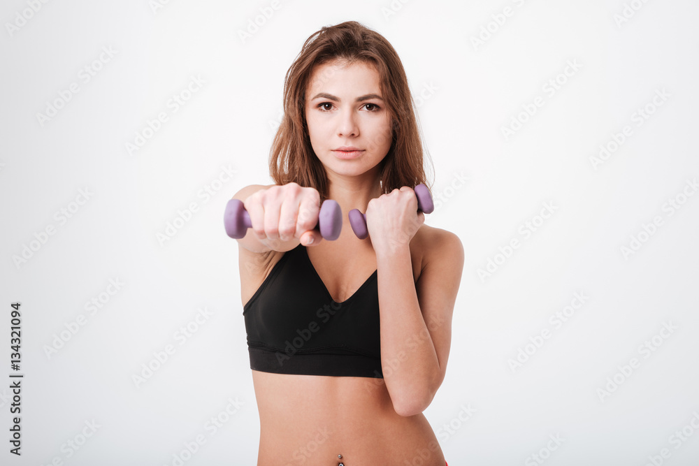 Pretty young lady make exercises with dumbbells Pretty young lady make exercises with dumbbells