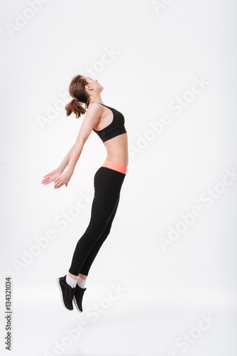Pretty young fitness woman jumping