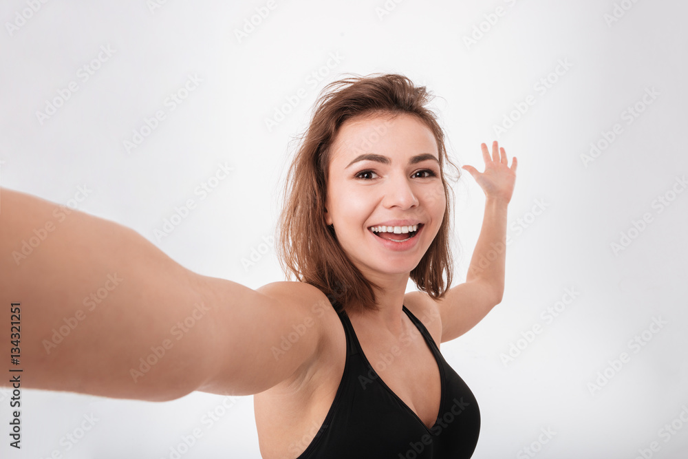 Cheerful young fitness woman make a selfie Cheerful young fitness woman make a selfie