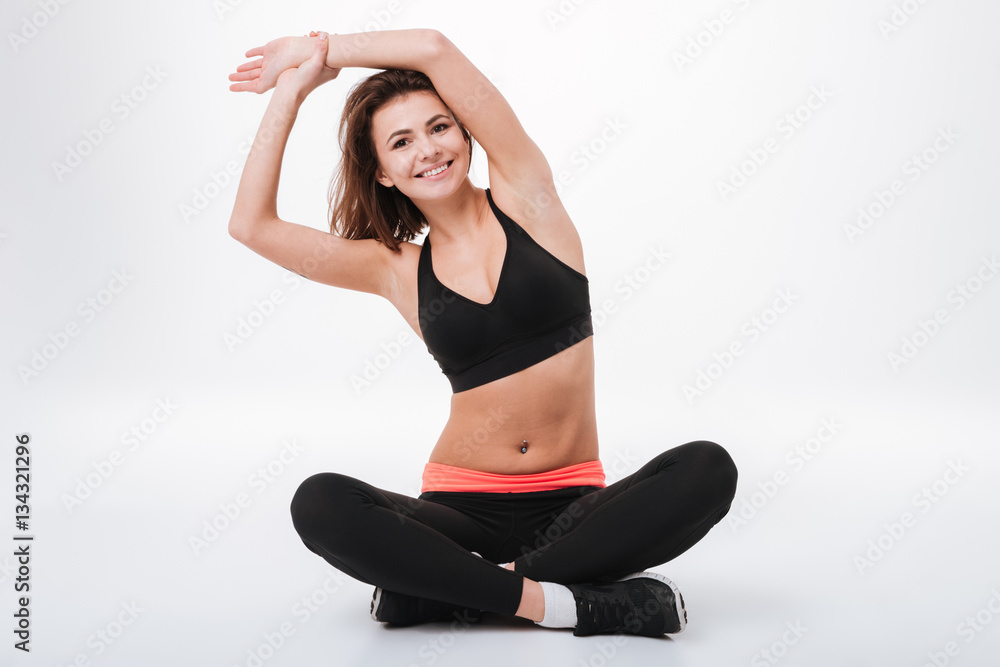 Fototapeta premium Happy young fitness lady make stretching exercises