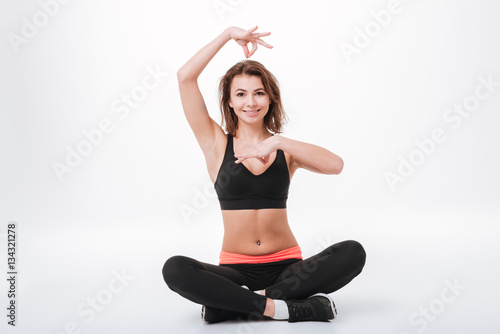 Cheerful young fitness lady make yoga exercises