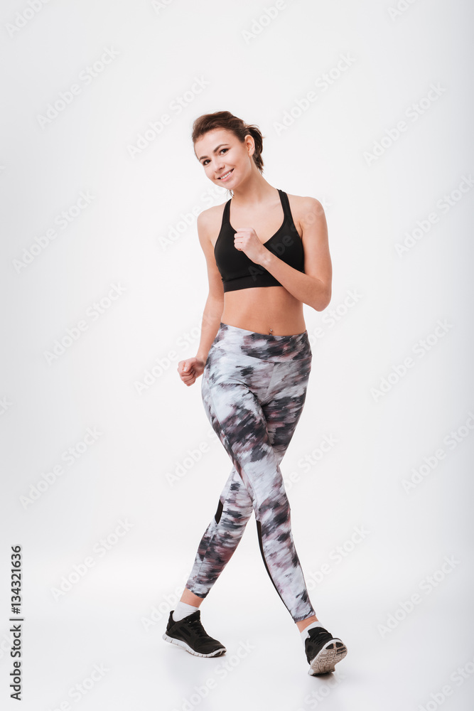 Cheerful young fitness woman make sport exercises Cheerful young fitness woman make sport exercises