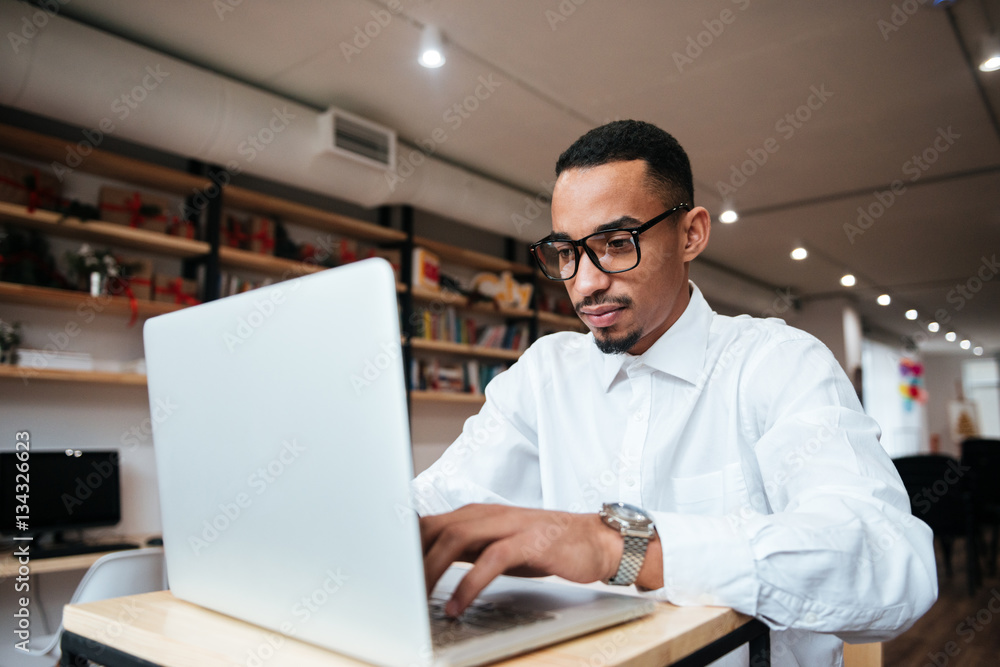 Handsome african businessman typing by laptop computer. Handsome african businessman typing by laptop computer.