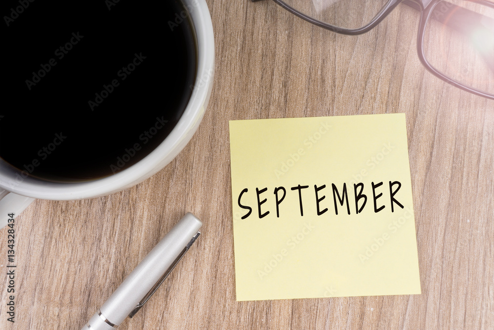 SEPTEMBER text on yellow note SEPTEMBER text on yellow note