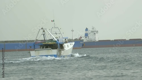 Fishing boat at sea
Shooting of a fishing boat sailing in the sea of Puglia between the merchant ships