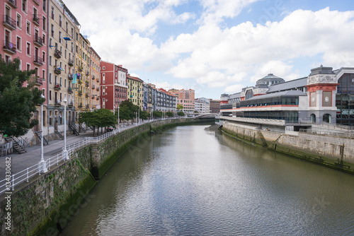 House facades in Bilbao along the Nervion river that runs through the city into the Cantabrian Sea. The apartment blocks are situated in the district San Frantzisko, on right the Mercado de la Ribera
