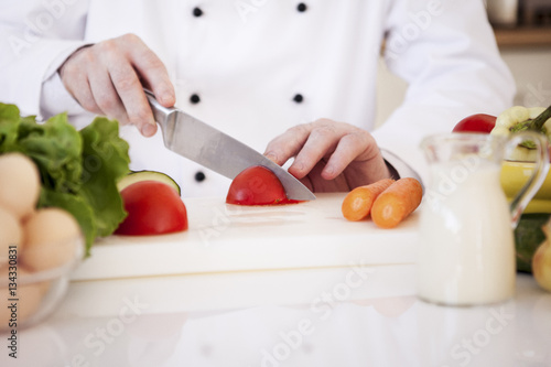 Chef Cutting a Tomato