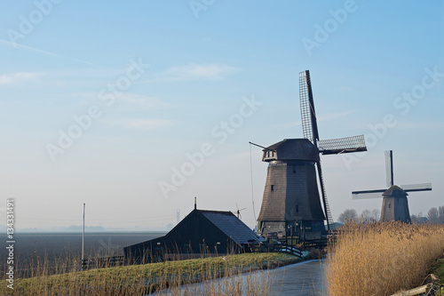 Dutch windmills by frozen water photo