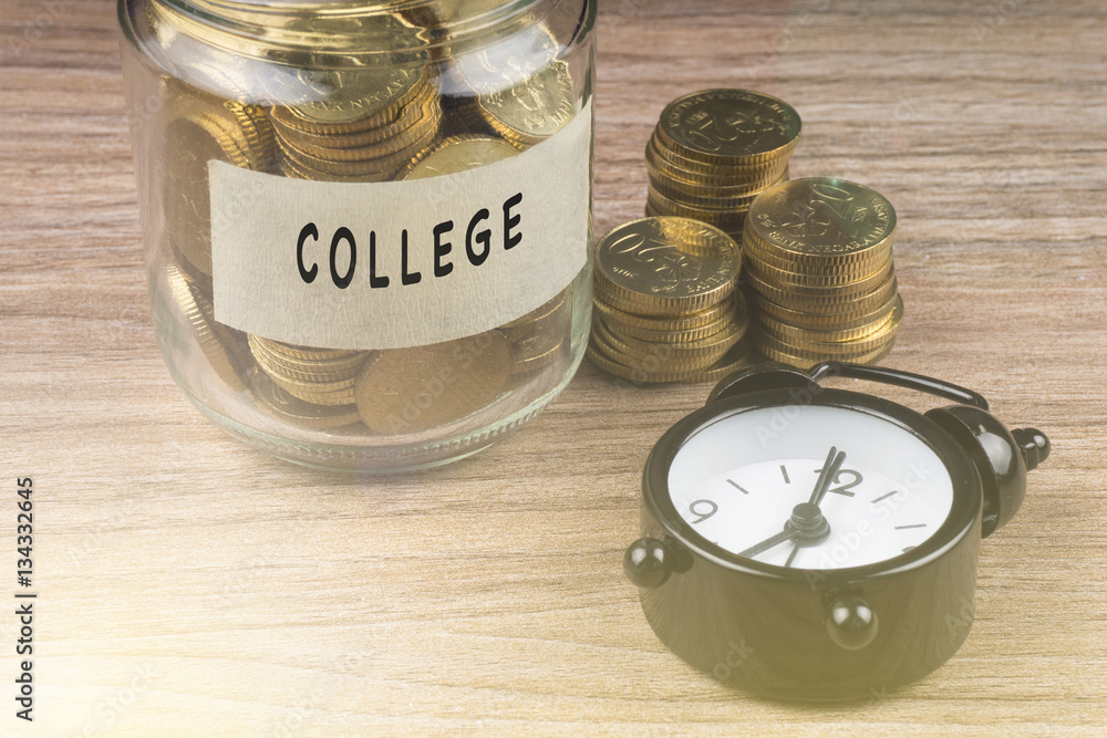 Coins in glass with COLLEGE label on wooden background. Financial concept. Coins in glass with COLLEGE label on wooden background. Financial concept.
