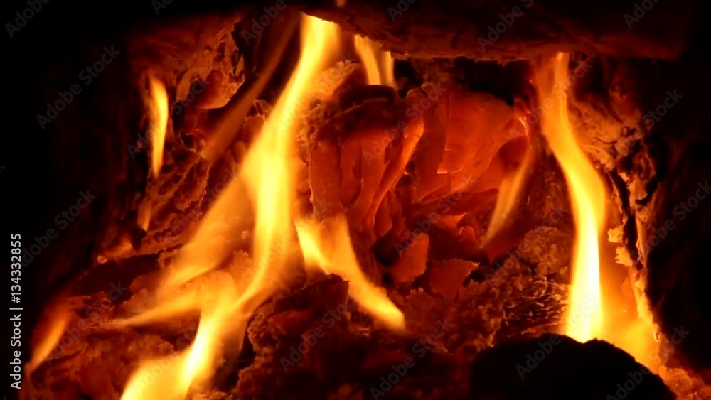 Fireplace full of bright burning wood and embers with the sound