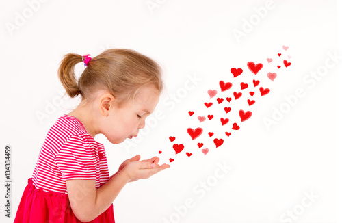 Little kid is sending heart shaped kisses photo