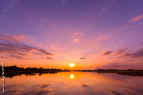 Sunset sky background with landscape of calm lake at sunset