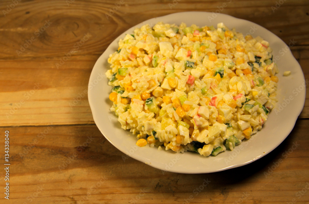 Salad with crab sticks sweet corn cucumber eggs and rice Salad with crab sticks sweet corn cucumber eggs and rice