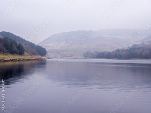 Dove stones reservoir on a cloudy winters January day after the rain had arrived. Oldham, Saddleworth, UK