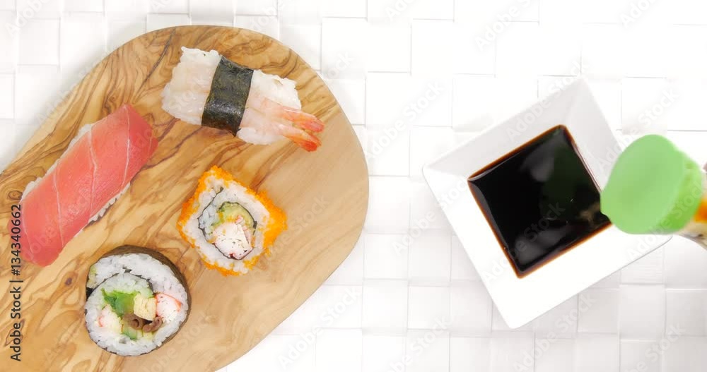 Pouring soy sauce beside a dish of tasty and fresh japanese sushi
Pouring soy sauce beside a dish of tasty and fresh japanese sushi