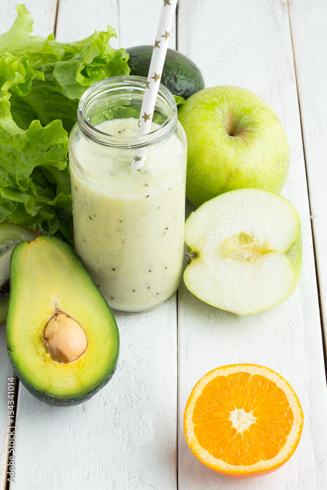 green smoothie in a bottle on a white background green smoothie in a bottle on a white background