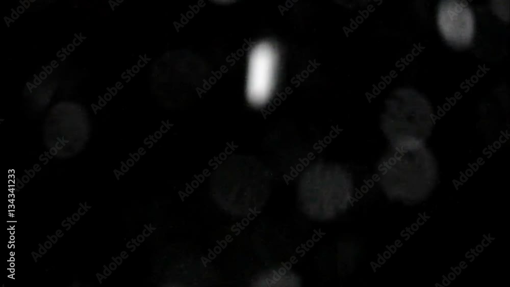 snow at night through the window glass with drops. Flying from left bottom. snow at night through the window glass with drops. Flying from left bottom.