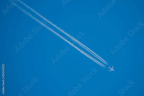 airplane contrail against clear blue sky