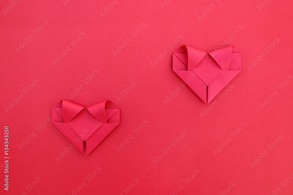 two folding red paper separated hearts on red for pattern and ba