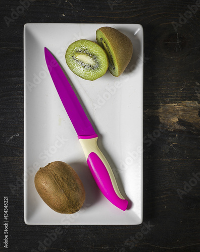 Kiwi Fruit and fuchsia knife, close up photo
