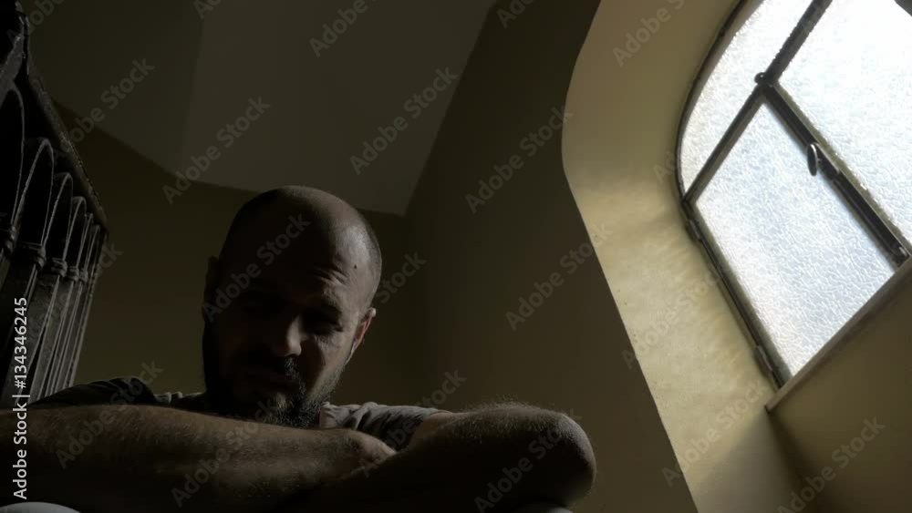 Man squatting on the stairs crying in despair Man squatting on the stairs crying in despair