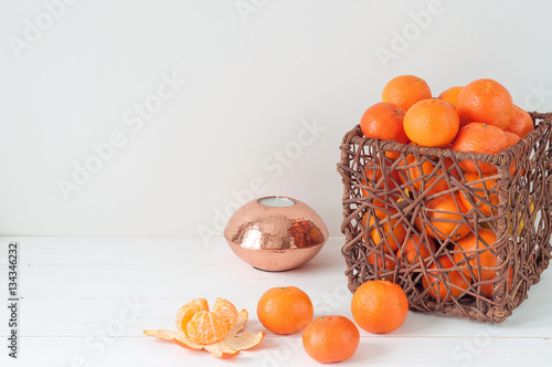 Minimal elegant composition with tangerines and vase photo