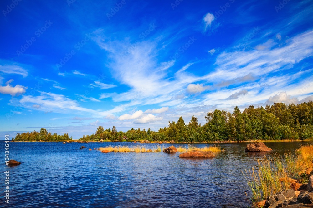 Sunny lake landscape in rural Finland
