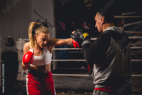 Girl Training on mitts with her boxing instructor