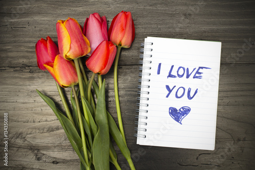 tulip bouquet and notepad with words "I love you"