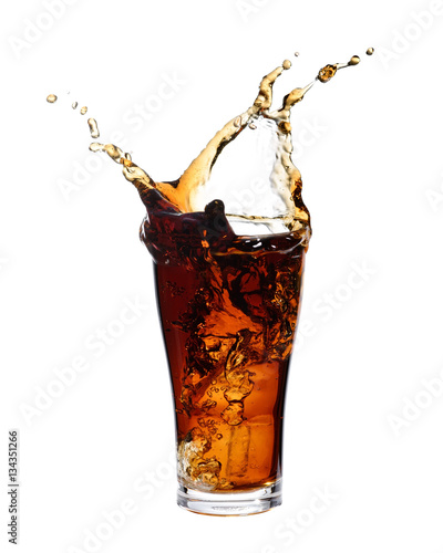 Canvas Print Cola splashing out of a glass., Isolated white background.