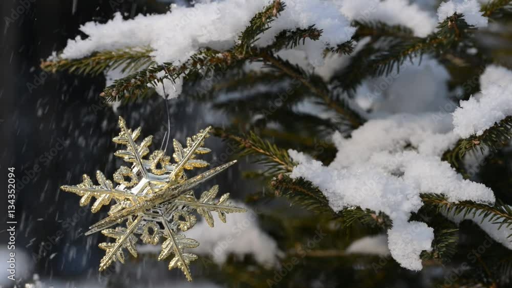 Christmas ornament on a snowy spruce twig Christmas ornament on a snowy spruce twig