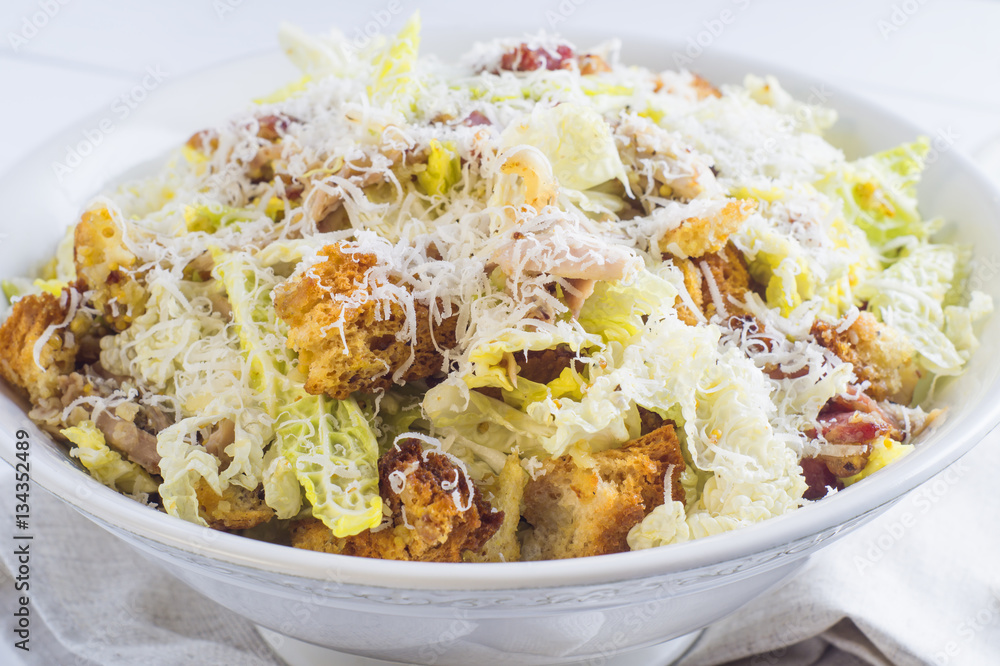 Caesar Salad with on white plate. Delicious Caeser salad with croutons, roasted chicken meat, parmesan cheese and cos lettuce, with sauce, healthy recipe, close-up. Healthy food. Caesar Salad with on white plate. Delicious Caeser salad with croutons, roasted chicken meat, parmesan cheese and cos lettuce, with sauce, healthy recipe, close-up. Healthy food.