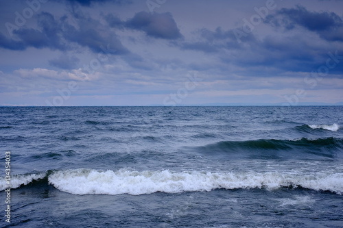 First snow on Lake Baikal  on background waves and colorful landskape