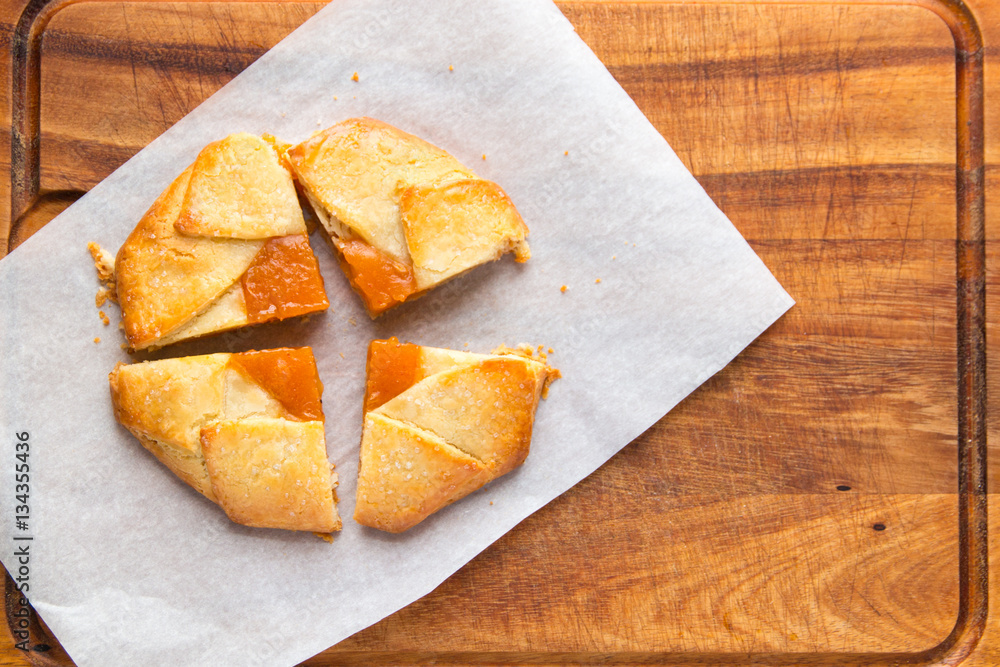Small tart pie with persimmon and peach jam, french galette. Small tart pie with persimmon and peach jam, french galette.