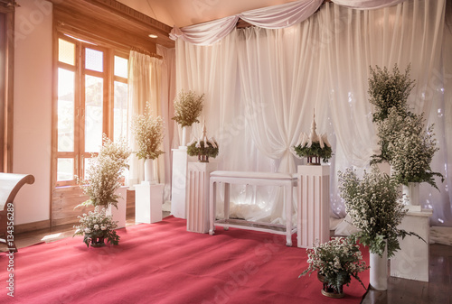 Interior ceremony wedding room decoration by red carpet and fabr