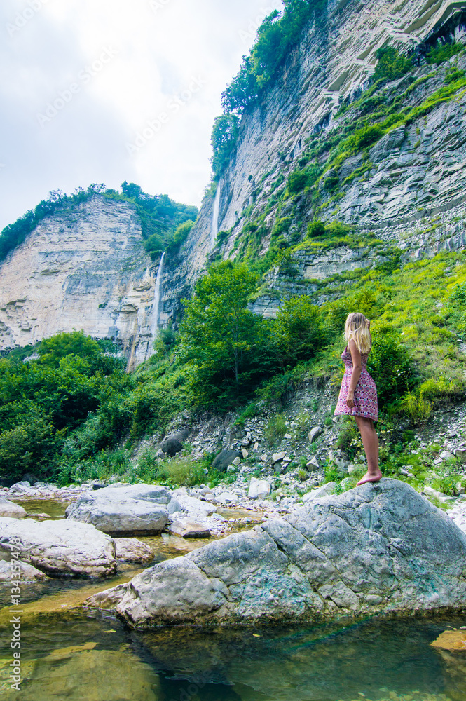 Girl enjoying huge Kinchkha Waterfall view near Kutaisi, Georgia