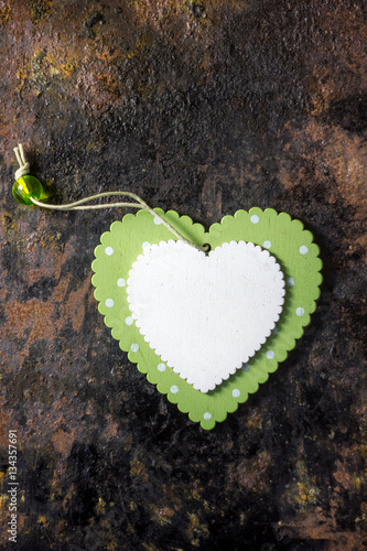 Green wooden heart and white wooden heart