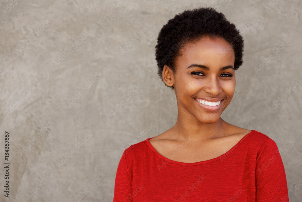 attractive young black woman in red shirt smiling attractive young black woman in red shirt smiling