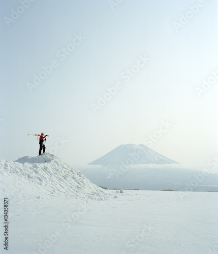 Man viewing snow covered volcano, Japan